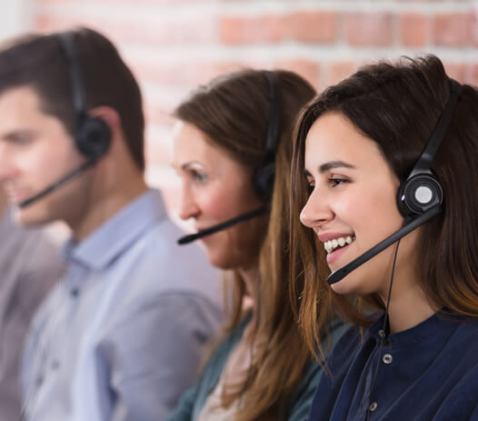 Smiling Contact Center Representatives on Headsets