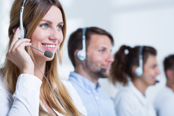 Smiling Call Center Representatives on Headphones