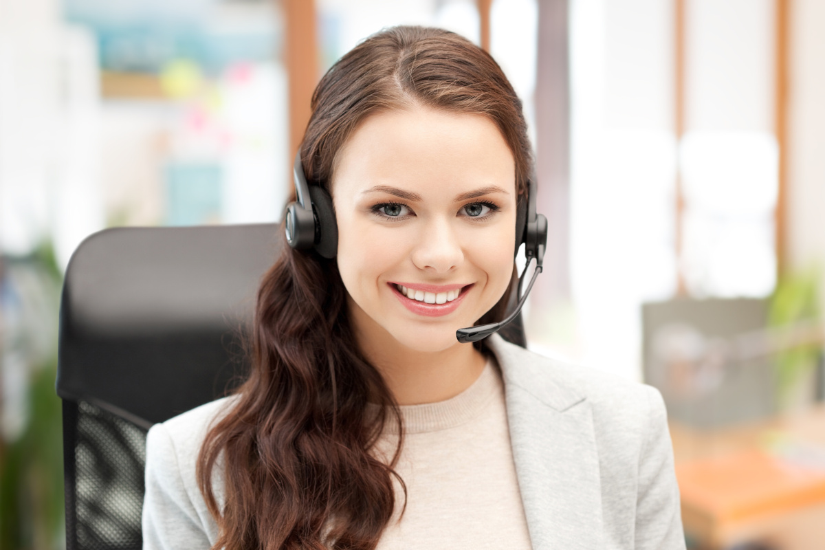 A person with a headset on smiling