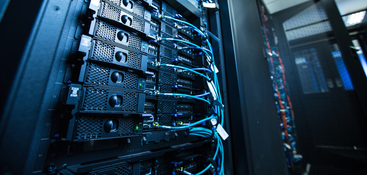 A close up view of a server rack with cables plugged into it